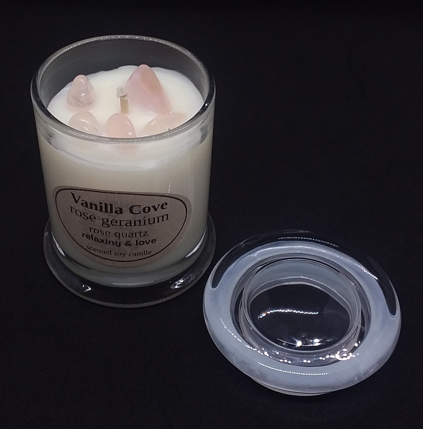 Vanilla Cove Soy Candle 45 hour Rose Geranium fragrance with Rose Quartz crystals in clear glass jar and glass lid